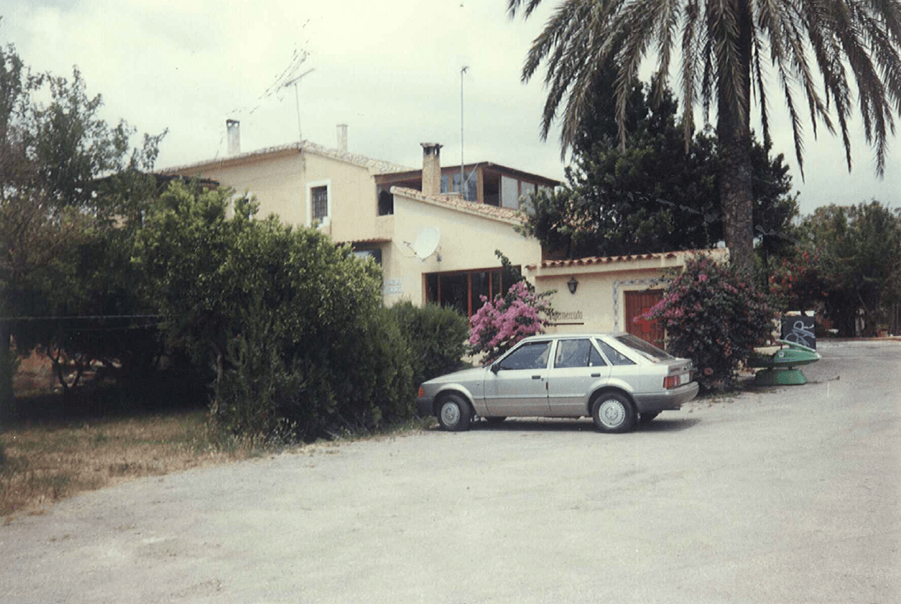 Antigua recepción y vivienda del camping, con un coche aparcado delante
